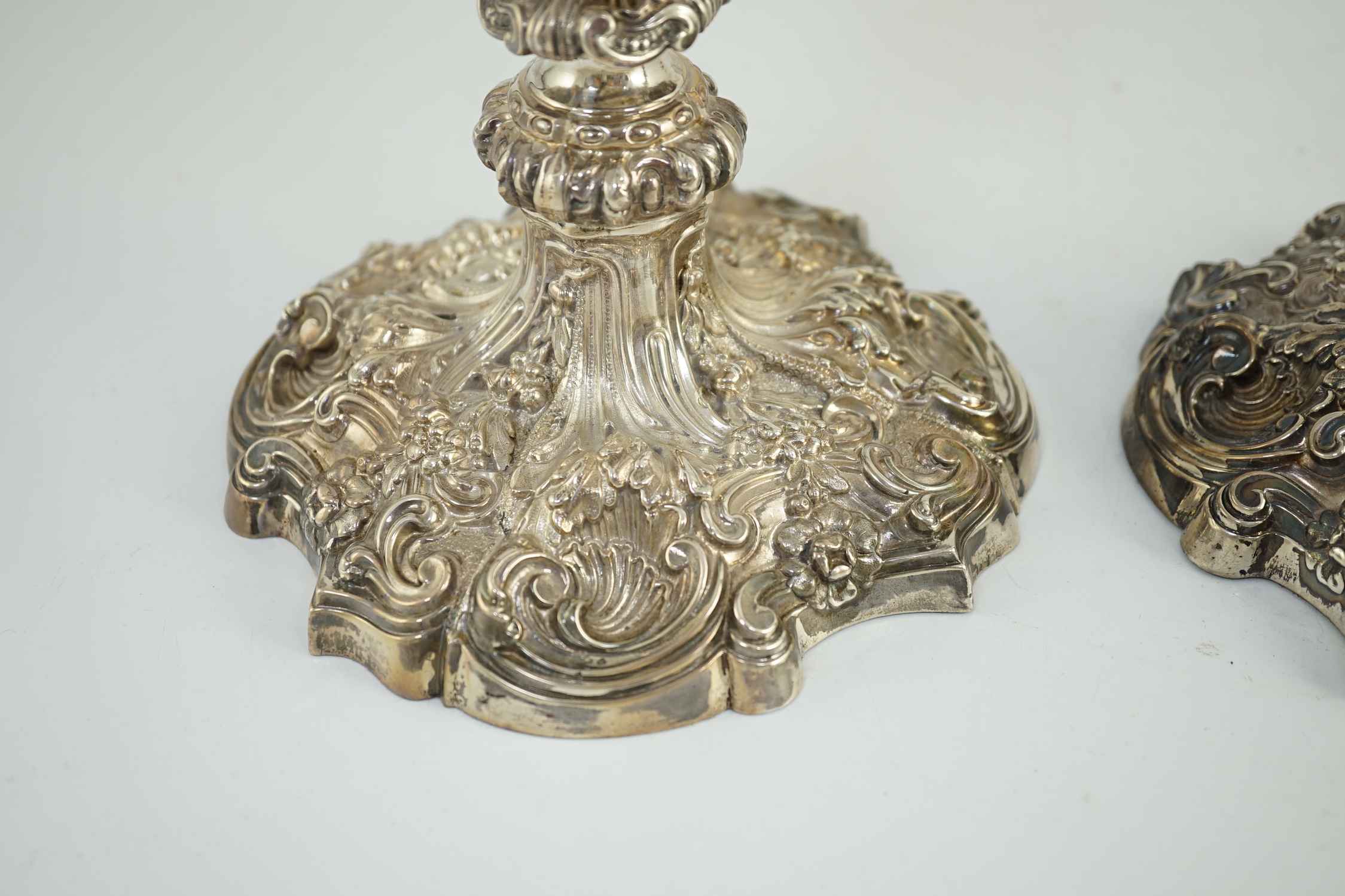 An ornate pair of Edwardian silver candlesticks, by Walker & Hall